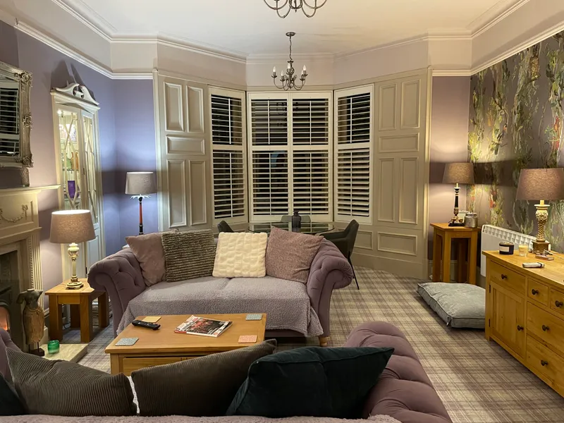 Shutters fitted to a bay window in a period living room