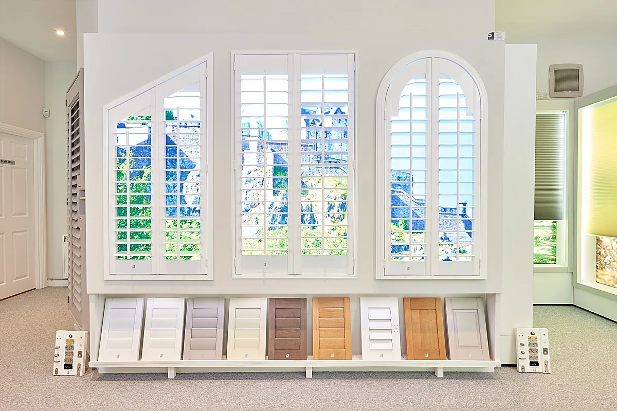 Shutter display wall at The Scottish Shutter Company Edinburgh Design Studio showing full size working displays in different styles and colours