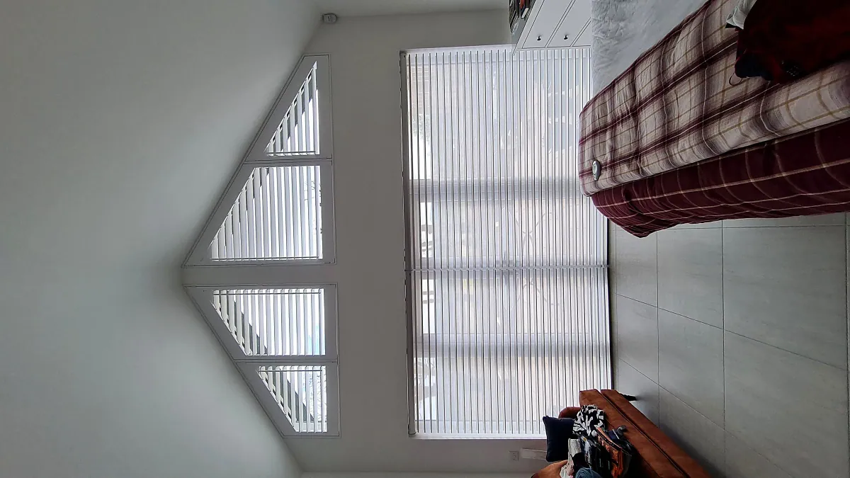 A shaped gable window with cellular blinds fitted to the angled glass