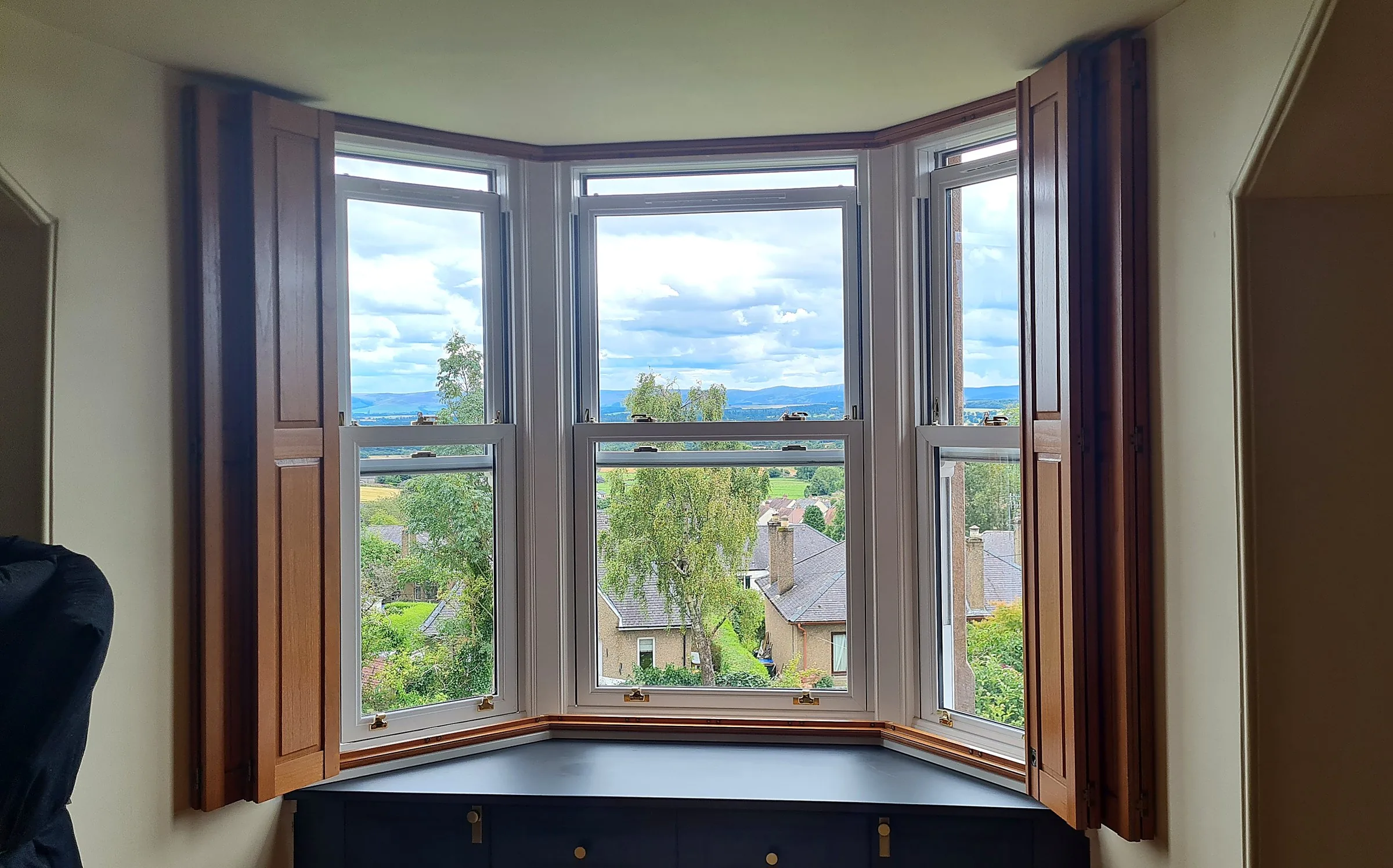 Solid panel shutters on bay windows