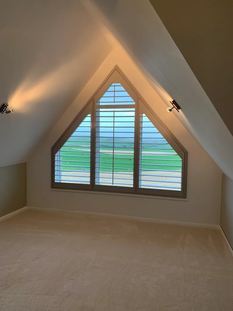 Triangular gable window shutters with sea view in Dounby, Orkney