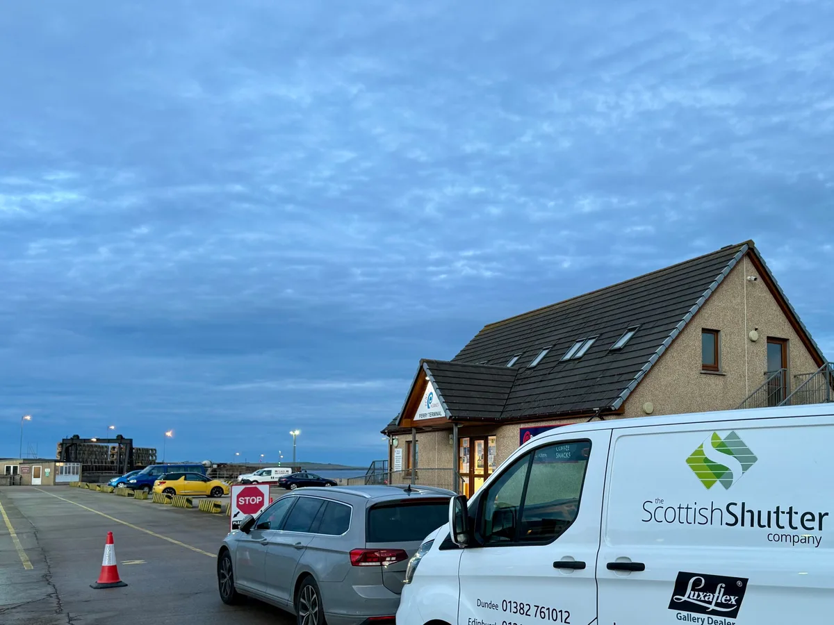 The Scottish Shutter Company van waiting at a Scottish ferry terminal at dawn, en route to Orkney