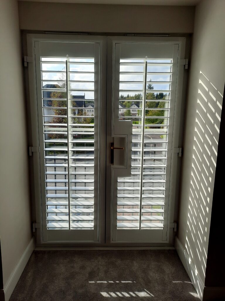 Window Shutters with a French Door Cutout for the Door Handle