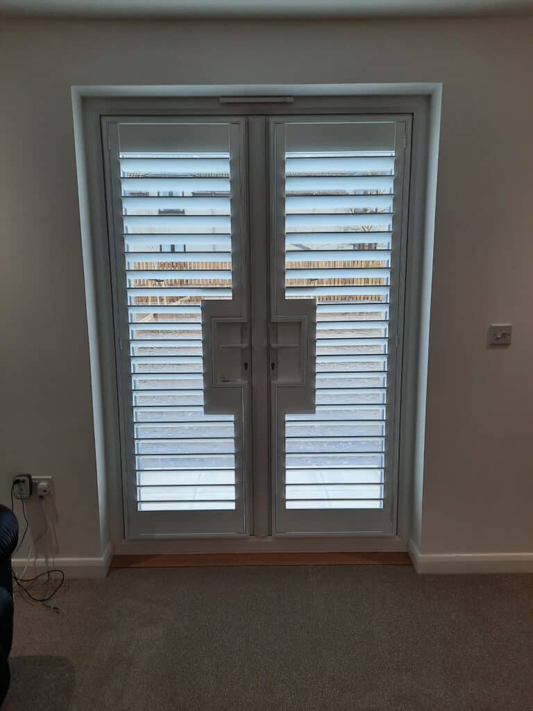 Window Shutters with a French Door Cutout for the Door Handle