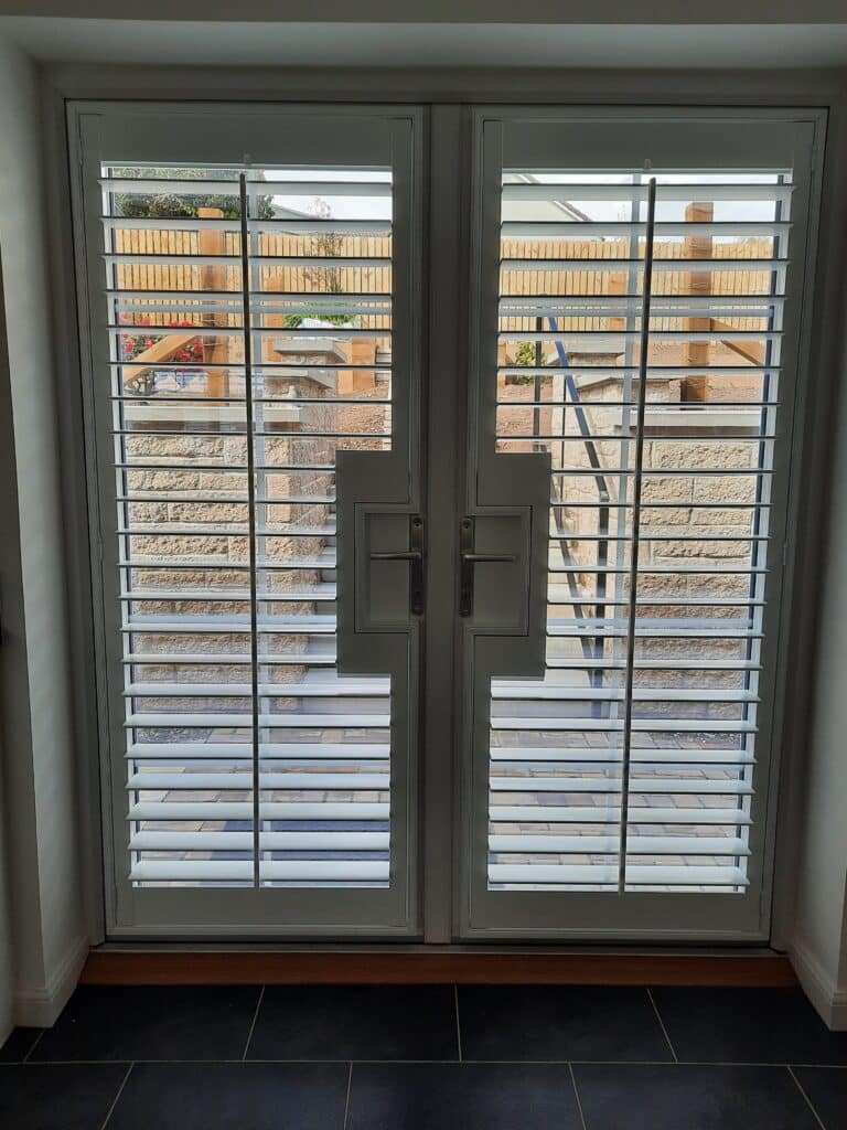 Window Shutters with a French Door Cutout for the Door Handle