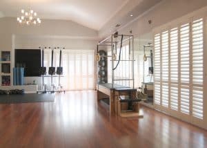 Portchester Security Shutters for Your Home 🏠 3 Portchester Security Shutters in a Gym with a Silk White finish from The Scottish Shutter Company