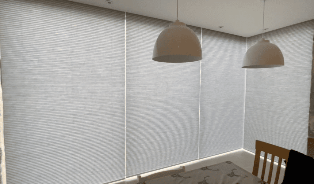 Translucent motorised Luxaflex Duette blinds on a large picture window